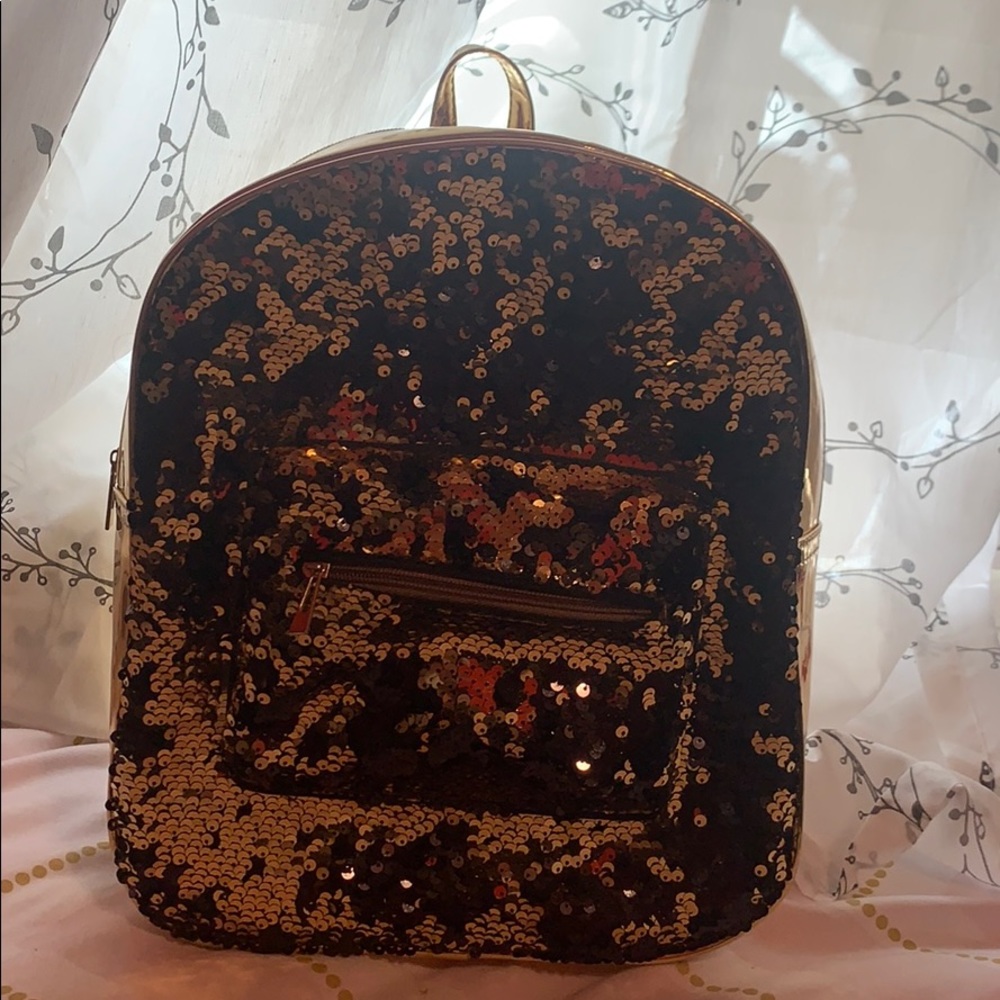 I am selling a medium gold/black backpack.